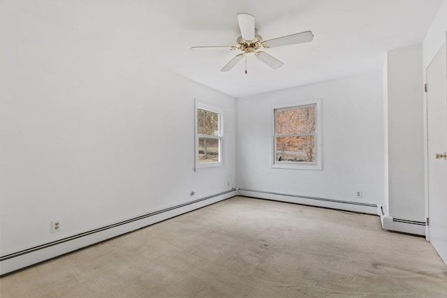 carpeted spare room with a baseboard radiator and a ceiling fan