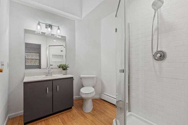 full bathroom with toilet, wood finished floors, baseboard heating, vanity, and a shower stall