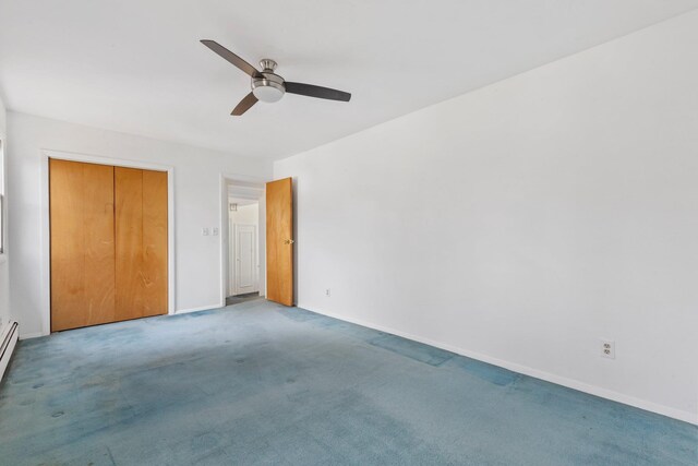 unfurnished bedroom with baseboards, ceiling fan, carpet flooring, a baseboard heating unit, and a closet