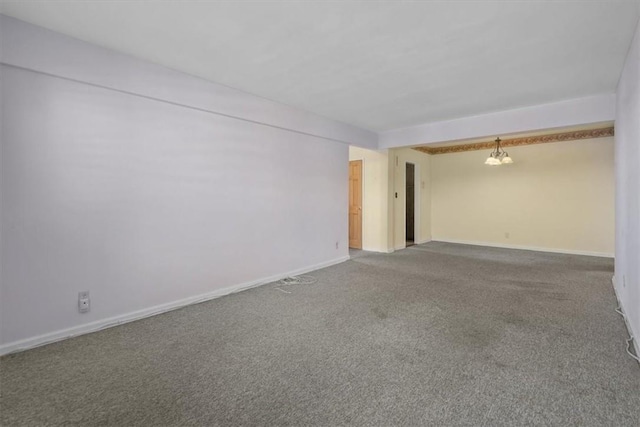 carpeted empty room with baseboards