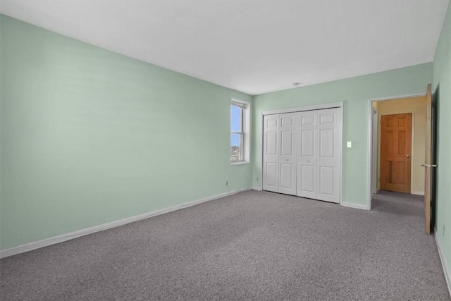 unfurnished bedroom featuring a closet, carpet flooring, and baseboards