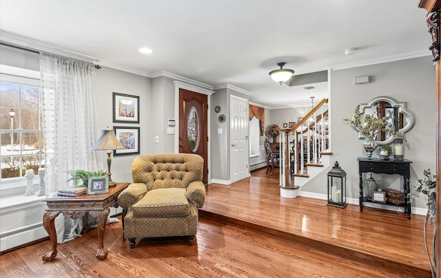 foyer entrance featuring stairs, baseboards, wood finished floors, and crown molding