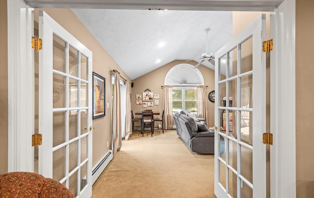 sitting room with carpet, french doors, a baseboard heating unit, vaulted ceiling, and ceiling fan