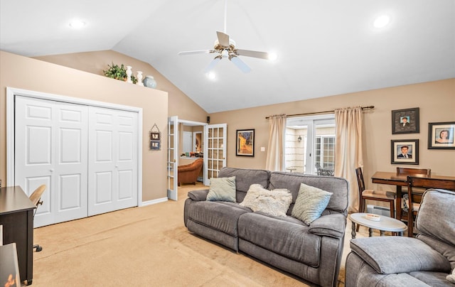 living room featuring lofted ceiling, ceiling fan, light colored carpet, and french doors