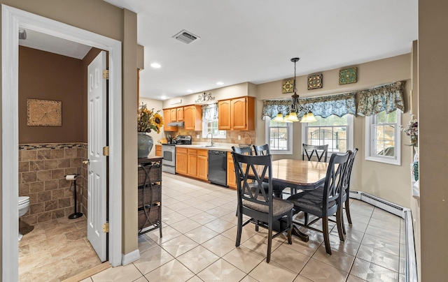 dining space with a chandelier, recessed lighting, a wainscoted wall, visible vents, and tile walls