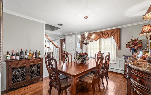 dining area featuring a wainscoted wall, crown molding, stairway, and wood finished floors