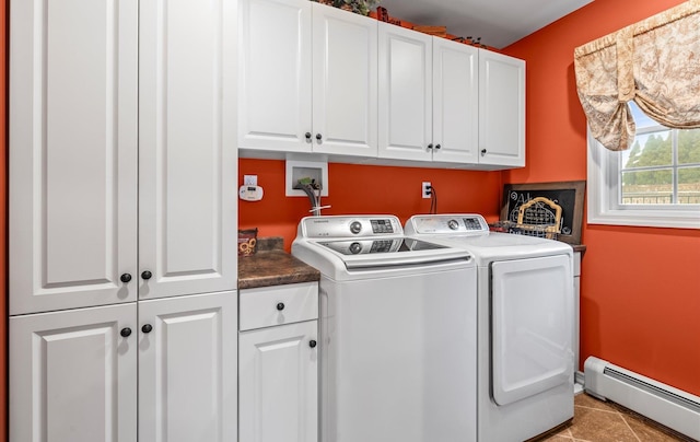 washroom with a baseboard radiator, cabinet space, washer and dryer, baseboards, and tile patterned floors