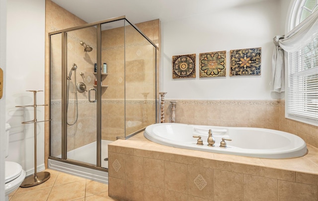 bathroom with toilet, a shower stall, a bath, and tile patterned floors