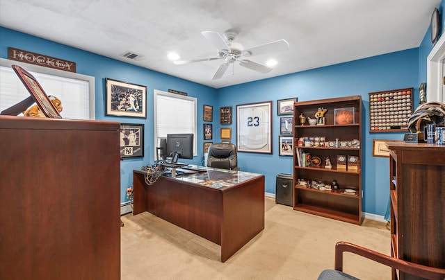 office featuring light carpet, visible vents, baseboards, ceiling fan, and a baseboard heating unit