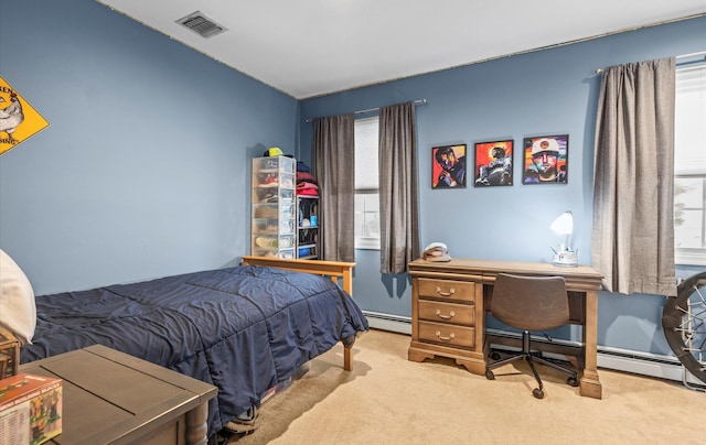 bedroom with a baseboard heating unit, carpet, and visible vents