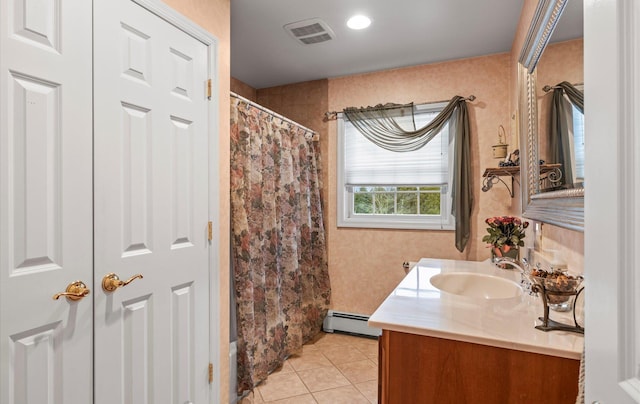 bathroom with visible vents, a shower with shower curtain, baseboard heating, vanity, and tile patterned flooring