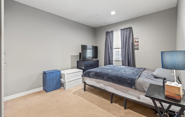 carpeted bedroom featuring baseboards and recessed lighting