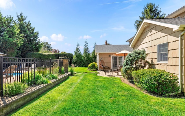 view of yard with a fenced in pool, fence, and a patio