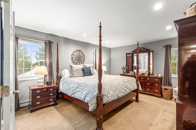 bedroom with recessed lighting, light carpet, and baseboard heating