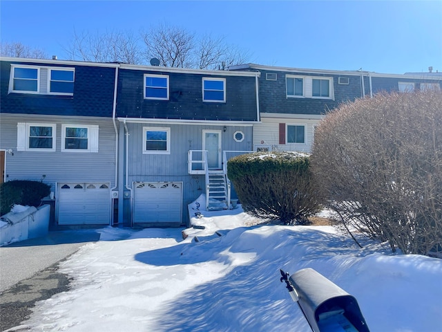 view of front of home featuring a garage and roof with shingles