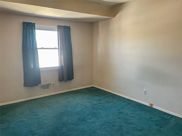 carpeted empty room with visible vents and baseboards