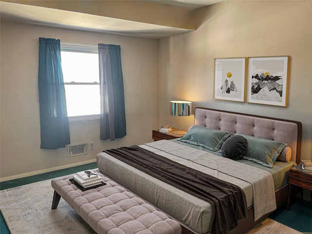 bedroom with baseboards and visible vents