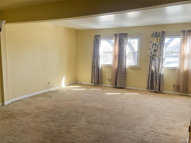 carpeted empty room with baseboards