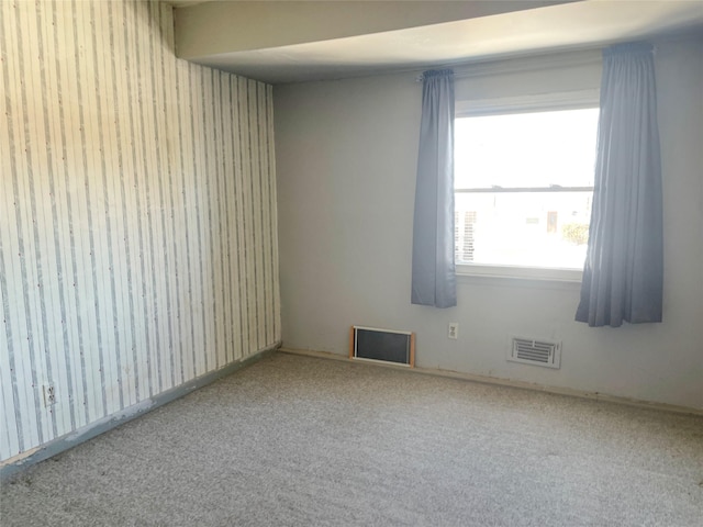 spare room featuring carpet and visible vents