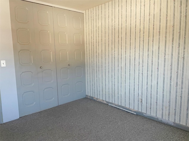 unfurnished bedroom with carpet and a closet