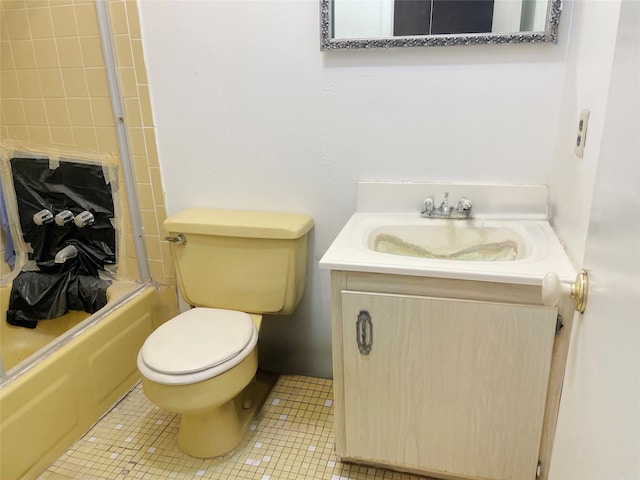 bathroom featuring toilet, bathtub / shower combination, tile patterned flooring, and vanity