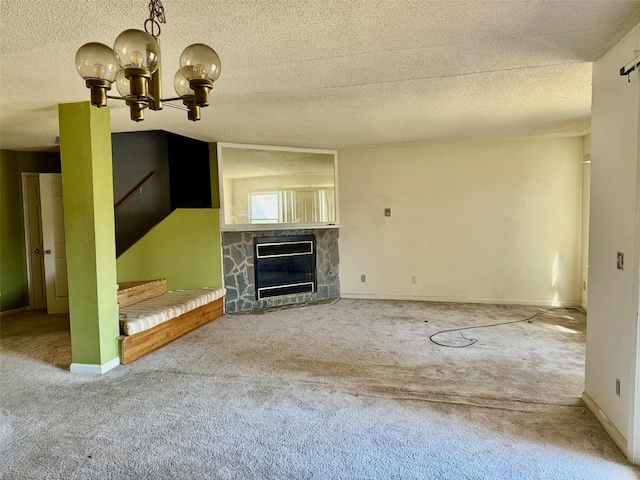 unfurnished living room featuring an inviting chandelier, carpet, and a fireplace