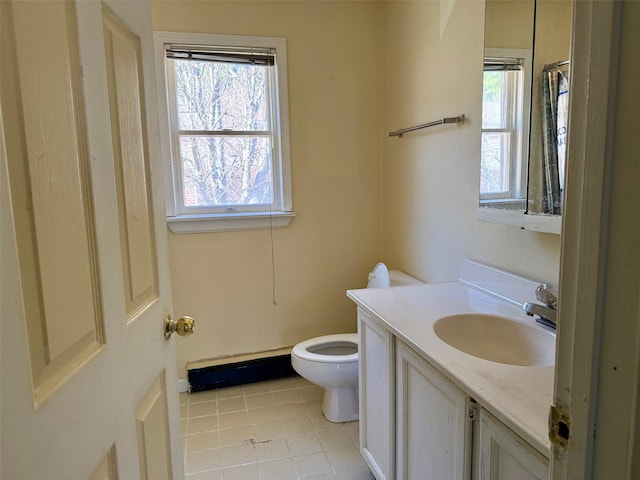 bathroom featuring toilet, tile patterned floors, a baseboard heating unit, and vanity