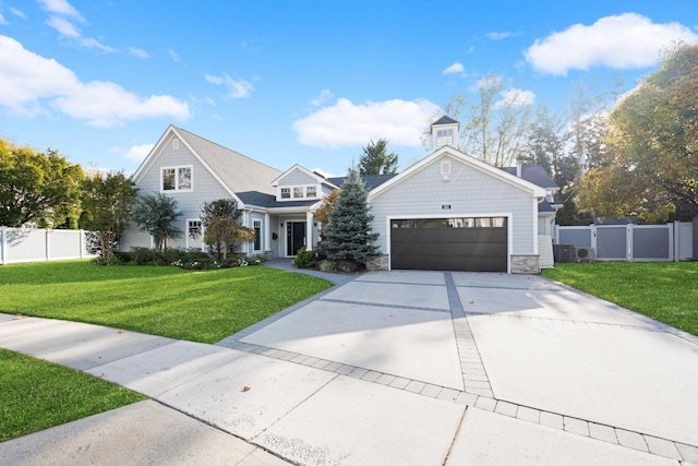 view of front of home featuring a garage, concrete driveway, stone siding, fence, and a front lawn