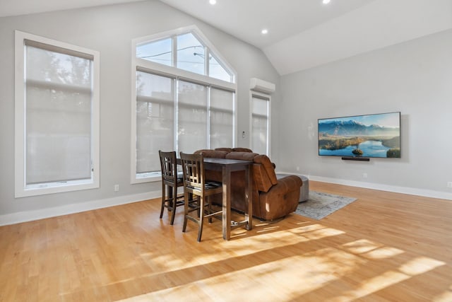 interior space featuring recessed lighting, vaulted ceiling, baseboards, and wood finished floors