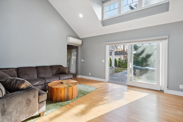 living room with recessed lighting, a wall mounted AC, wood finished floors, high vaulted ceiling, and baseboards