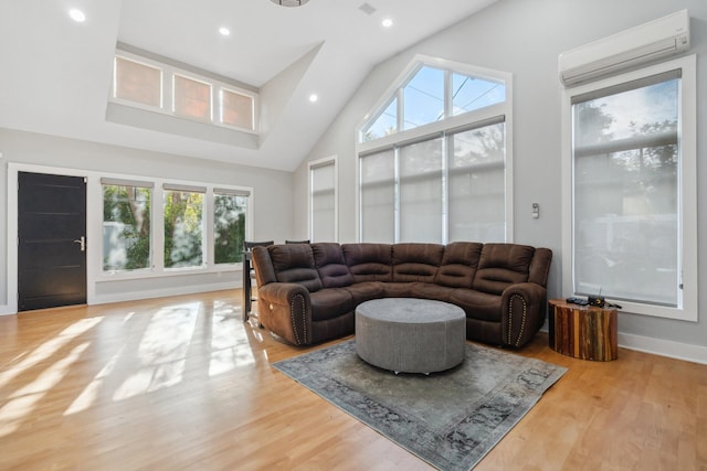 living area with high vaulted ceiling, recessed lighting, wood finished floors, baseboards, and a wall mounted air conditioner