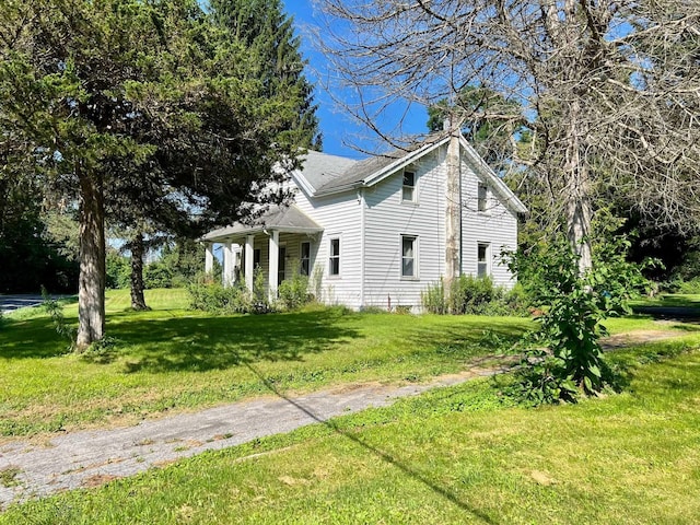 view of side of property with a lawn