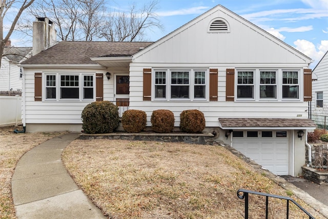 ranch-style house with a garage, a shingled roof, and a chimney