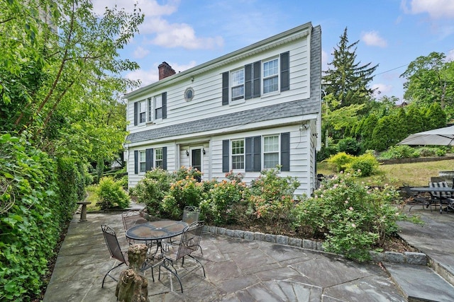 2711 Edgehill Ave, Bronx, NY 10463 - view of front of property featuring a patio, a chimney, and outdoor dining space