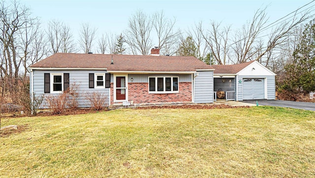 single story home with aphalt driveway, brick siding, a chimney, a garage, and a front lawn