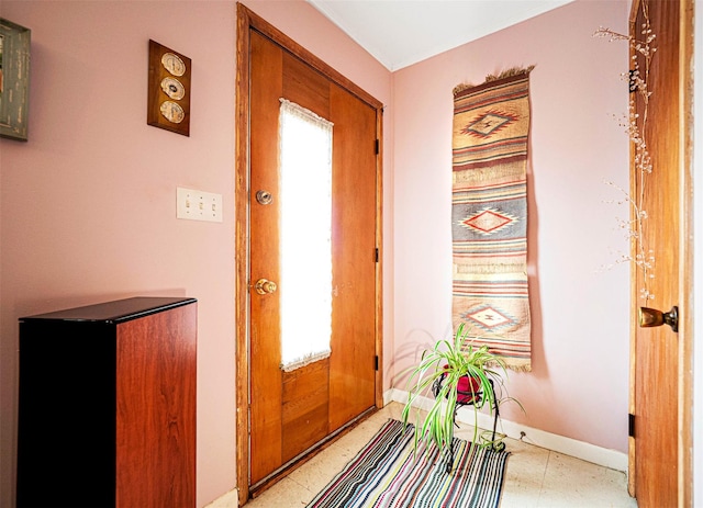 doorway featuring baseboards and a wealth of natural light