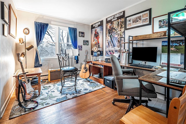 office area with wood-type flooring, crown molding, and baseboards