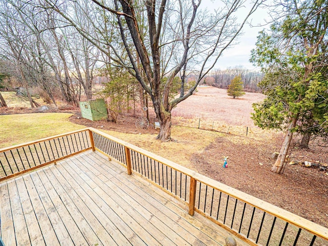 wooden terrace with a yard and an outdoor structure