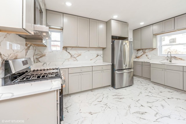 kitchen featuring appliances with stainless steel finishes, recessed lighting, a sink, and gray cabinetry