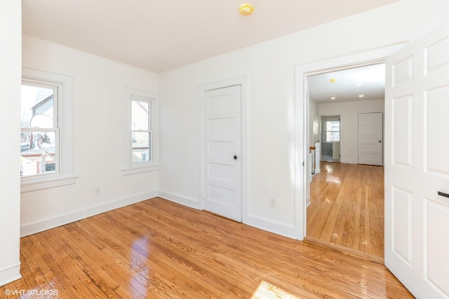 empty room with light wood-type flooring and baseboards