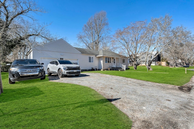 ranch-style home with driveway, an attached garage, and a front lawn