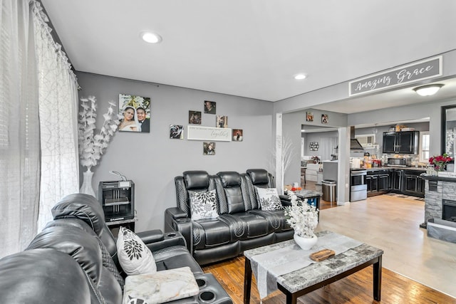 living room with light wood-style floors and recessed lighting