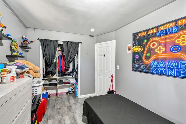 bedroom featuring baseboards and wood finished floors