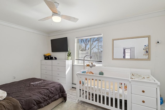 bedroom featuring a baseboard radiator, ceiling fan, and crown molding