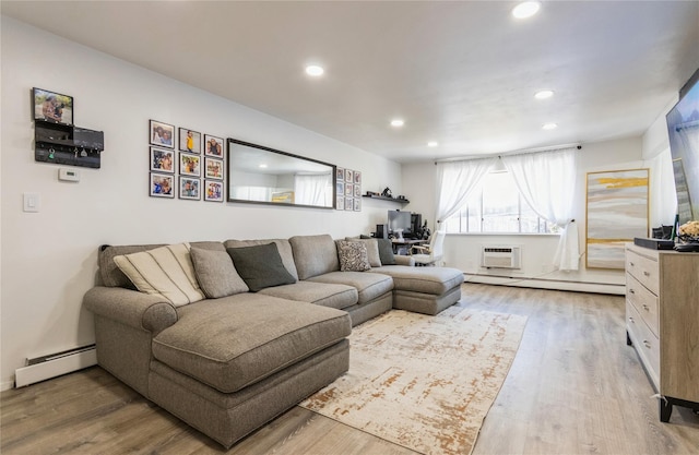 living room with a wall unit AC, wood finished floors, a baseboard radiator, recessed lighting, and a baseboard heating unit