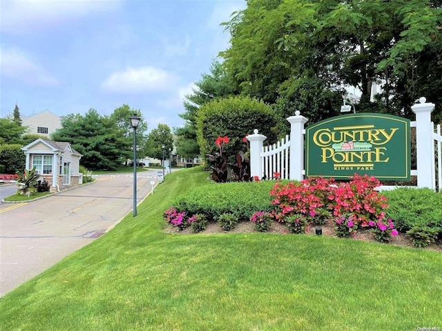 community sign featuring a lawn