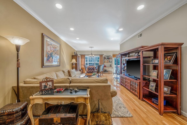 living area with light wood-style floors, recessed lighting, visible vents, and ornamental molding