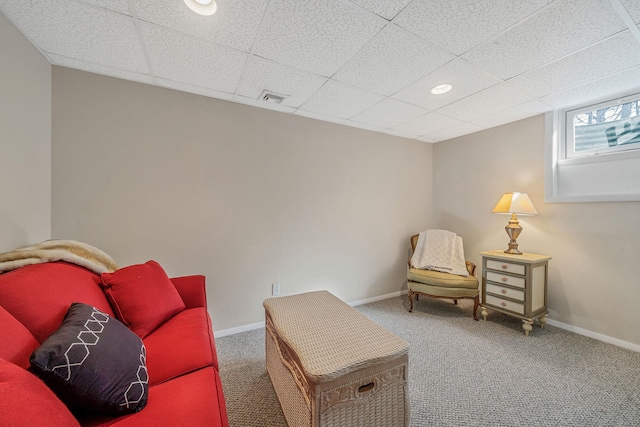 sitting room with carpet floors, baseboards, visible vents, and a paneled ceiling