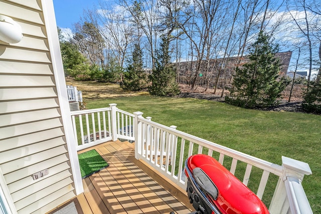 wooden terrace featuring a yard