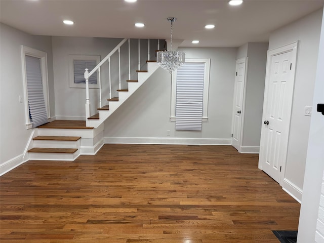 interior space featuring recessed lighting, baseboards, and wood finished floors